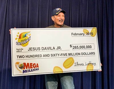 Jesus Davila Jr. holding their winning cheque