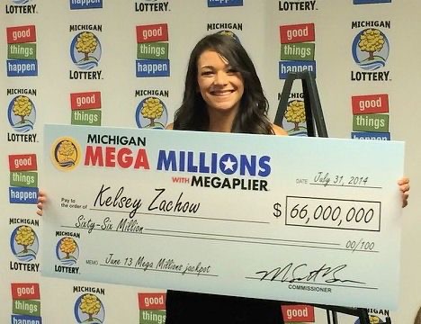 Kelsey Zachow holding their winning cheque