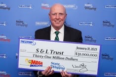 S & L Trust holding their winning cheque